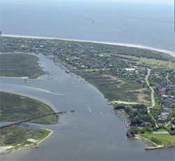 An aerial photo of Sullivan's Island, SC showing a waterway and the Atlantic Ocean